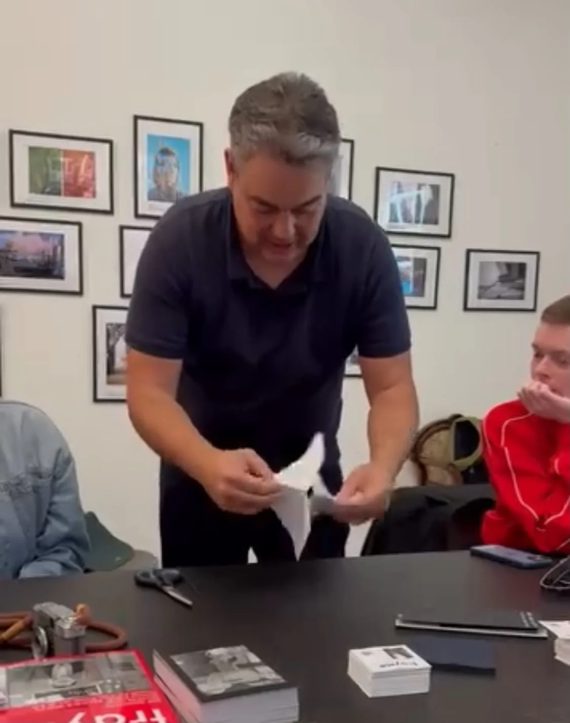 Dennis Misser folding a printed sheet into a zine