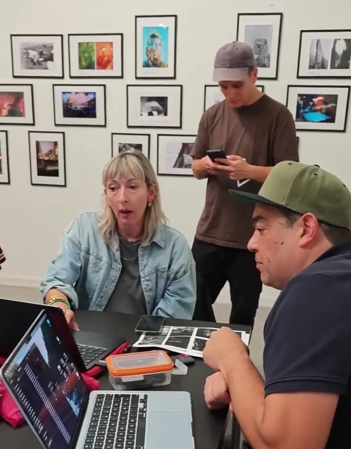Choosing photographs on a laptop at the workshop table